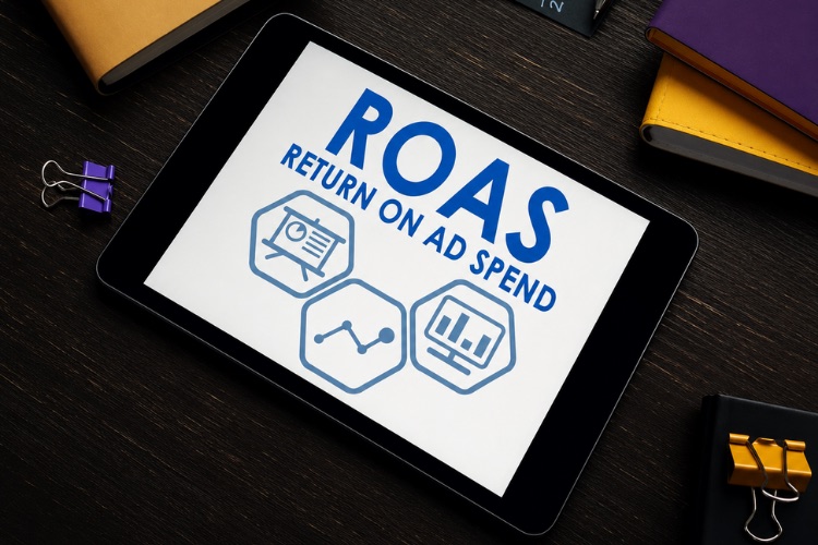 Tablet displaying ROAS, return on ad spend, with reporting, trend, and analytics icons