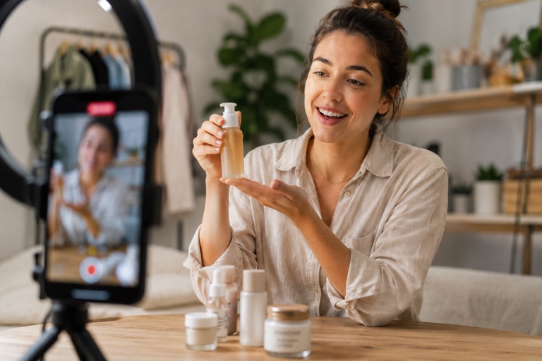 A creator filming an authentic skincare product demonstration for TikTok with a ring light